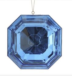 a blue glass ornament hanging from a chain