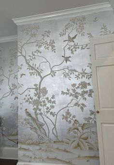 the wall paper has birds on it and is painted with gold leafy designs,