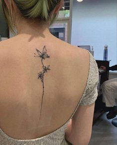 a woman with a tattoo on her back