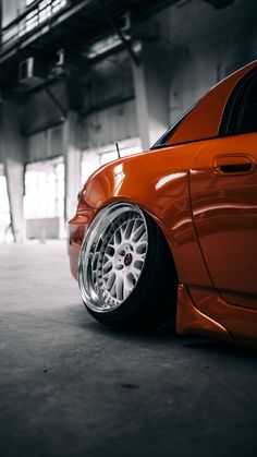 an orange car parked in a parking garage