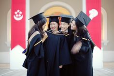 three young women in graduation gowns and caps are posing for a photo with each other