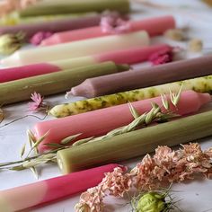 several different colored sticks with flowers on them