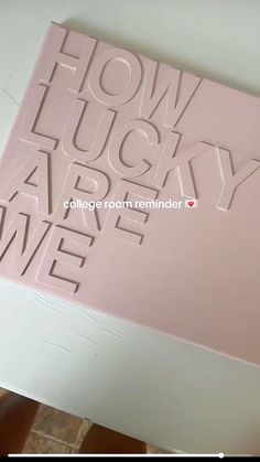 a pink book with the words how lucky are we on it