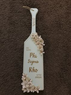 a sign with flowers on it that says phi sigma rho