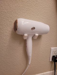 a white hair dryer sitting on top of a wall