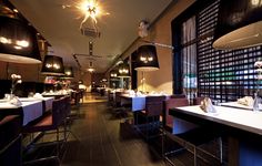 an empty restaurant with wooden floors and tables