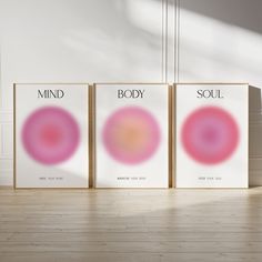 three posters with the words mind, body and soul on them in front of a white wall