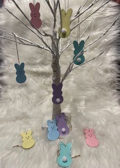 a small tree decorated with easter eggs and bunnies