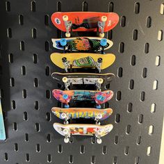 four skateboards are hanging on the wall