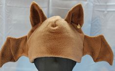 Ultrasoft fleece BAT hat with freestanding, pointed 3D ears, a solid base in natural colors, small bat wings on the sides, and matching ear lining. This hat's cozy layers will keep you warm through the coldest days! Perfect for cold weather outdoor fun, a costume, or to make a statement.   Will fit most adults. Multiple color variations are available so PLEASE specify which color style is preferred. If choosing the Custom Colors option, please write your color choices in the "Personalization" fi Bat Hat, Fleece Hat, Natural Colors, Multiple Color, Skull Cap, Outdoor Fun, Bat Wings, Different Fabrics, Cold Day