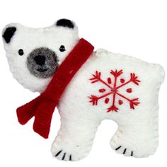 a white polar bear with a red scarf around its neck