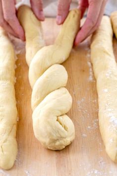 someone is kneading dough on a wooden board