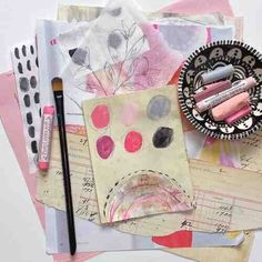 an assortment of art supplies and paper on top of each other