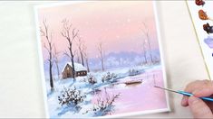 someone is painting a winter scene with watercolors