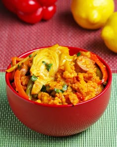 a red bowl filled with food on top of a table