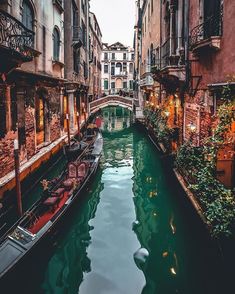 a canal with gondolas and buildings on both sides