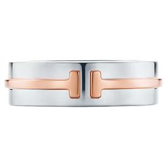 Authentic Tiffany T Wide Band Ring in Sterling Silver and 18k Rose Gold. The bold lines of this timeless design highlight the powerful form of the letter "T." As multifaceted as it is iconic, the Tiffany T collection is a tangible reminder of the connections we feel but can't always see. Wear this ring on its own or stack with other Tiffany rings for a striking look. This band is beautifully crafted in sterling silver and 18k rose gold with a high polish finish. The band is 5.9 mm wide, size 4.2 Tiffany Engagement Ring Men, Tiffany T1 Ring, Mens Tiffany Rings, Tiffany Etoile Band, Tiffany Mens Wedding Band, Tiffany Band, Mens Bracelet Designs, Tiffany Rings, Tiffany T