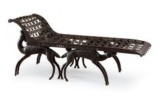 an intricately carved bench and two small deer figurines are shown in front of a white background