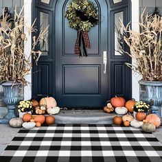 a blue front door decorated with pumpkins and gourds