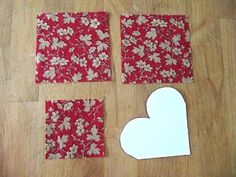 four pieces of paper cut out to look like hearts and flowers on a wooden surface