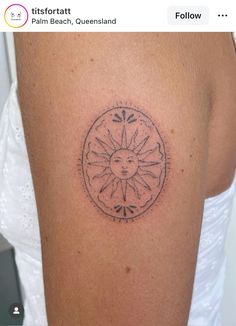 a woman's arm with a sun tattoo on the left side of her body