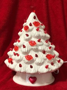 a white ceramic christmas tree with red hearts