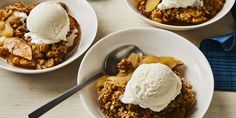 three bowls filled with food and ice cream on top of a wooden table next to two spoons