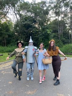 three people in costumes posing for the camera