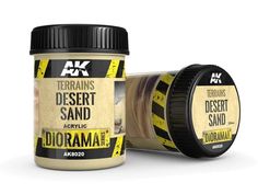 two jars of desert sand next to each other on a white surface with yellow tape around them