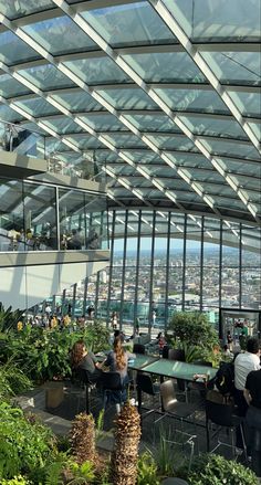 people are sitting at tables in the sky garden