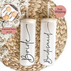 two personalized candles are sitting on a wicker basket