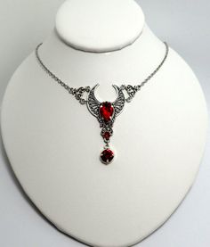 This is a new handmade necklace. It is made with antiqued silver plated filigrees, accented with high quality BRIGHT RUBY RED glass rhinestones. Decorated portion is 2 3/8" wide and 2 1/2" tall in the center. Necklace is adjustable 15-18" with a lobster clasp and chain extender. If you would like a different length, please send us a message.Matching headpiece and earrings are listed in our store. Red Metal Filigree Jewelry, Red Bohemian Filigree Jewelry, Bohemian Red Filigree Jewelry, Antique Silver Necklace, Poison Ring, Female Jewelry, Red Stones, Romantic Goth, Gothic Victorian