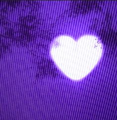 a white heart on a purple screen with trees in the backgroung area