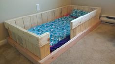 a bed made out of pallet wood in a room with carpeted flooring