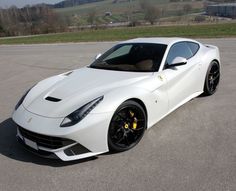 a white sports car parked in a parking lot