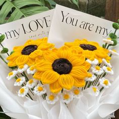 two greeting cards with sunflowers and daisies on them, sitting next to each other