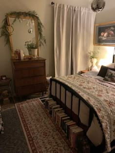 a bed room with a neatly made bed and lots of books on the floor next to it