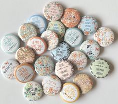 a pile of buttons with different sayings on them