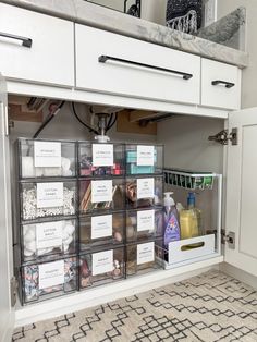 the drawers are filled with cleaning products and other things to use in the bathroom area