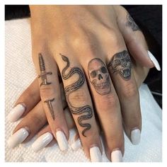 two hands with different tattoos on them, one has a snake and the other has a skull