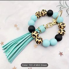 the bracelet is decorated with leopard print beads and tassels