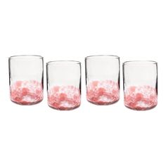 four glasses filled with pink liquid sitting next to each other