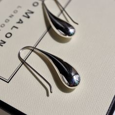 The silver liquid metal effect that gives them the appearance of a fresh raindrop is a unique and elegant that is sure to catch the eye. The contemporary design of the earrings with a teardrop shape and fixed hook drop setting makes them easy and fuss-free to wear, which is always a plus. The polished finish adds to their sleek and modern look, while the silver liquid metal effect gives them an organic and natural feel. these Sterling Silver liquid Drop Earrings are a beautiful and sophisticated Sterling Silver Teardrop Earrings With Shiny Finish, Modern Teardrop Drop Earrings For Everyday, Gift Shiny Finish Teardrop Earrings, Modern Silver Drop Earring Set, Silver Drop Earrings With Shiny Finish, Minimalist Metal Teardrop Drop Earrings, Modern Teardrop Earrings For Gift, Modern Drop Earrings For Pierced Ears, Shiny Finish Teardrop Earrings As A Gift