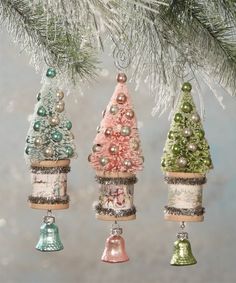 three christmas ornaments hanging from a tree