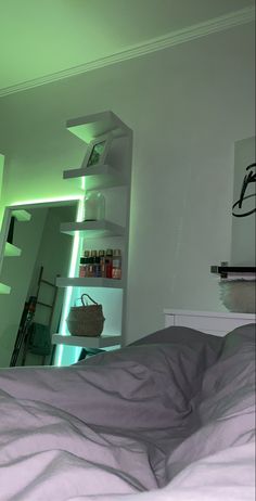 a bed with a white comforter and some shelves