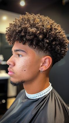 23 Curly Hairstyles for Men to Embrace Your Natural Texture Curly Afro Taper Fade, Blowout Fade Curly Hair, Curly Hair With Taper, Curls Hairstyles Men, Curly Hair Mens Cut, Mens Highlights Dark Hair, Haïr Cut Curly Hair, Afro Taper Fade Black Men, Fade With Curly Hair