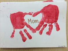 a mother's handprint with the word mom on it and two hands in the shape of a heart