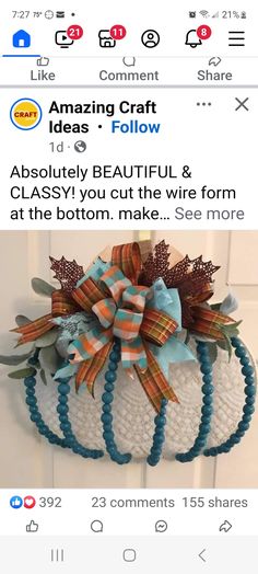 a white pumpkin decorated with blue and orange bows