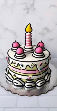 a birthday cake decorated with pink and white icing, topped with a single candle