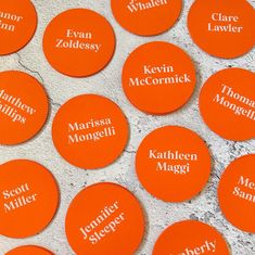 many orange buttons with names on them